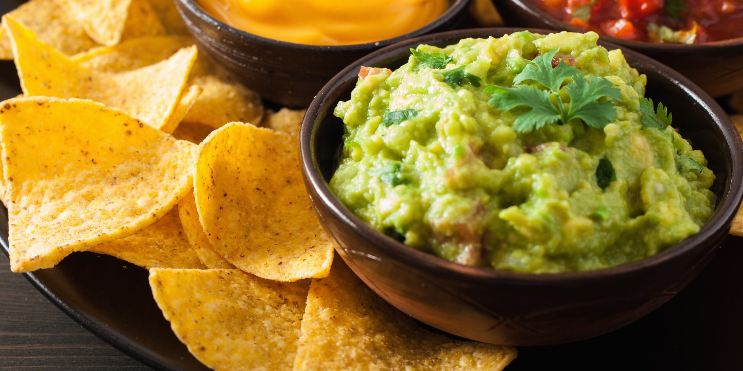 mexican nachos tortilla chips with guacamole, salsa and cheese dip